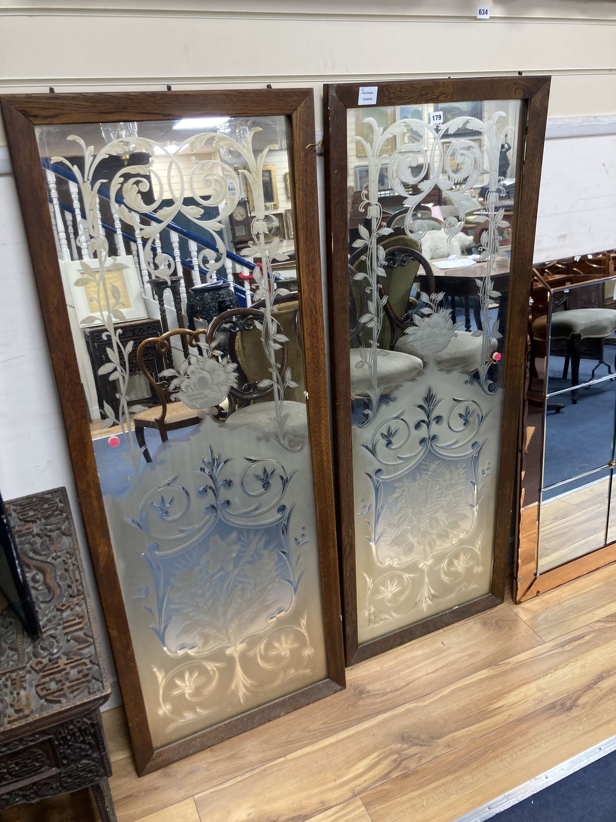 A pair of Victorian oak framed etched glass panels, width 55cm height 144cm